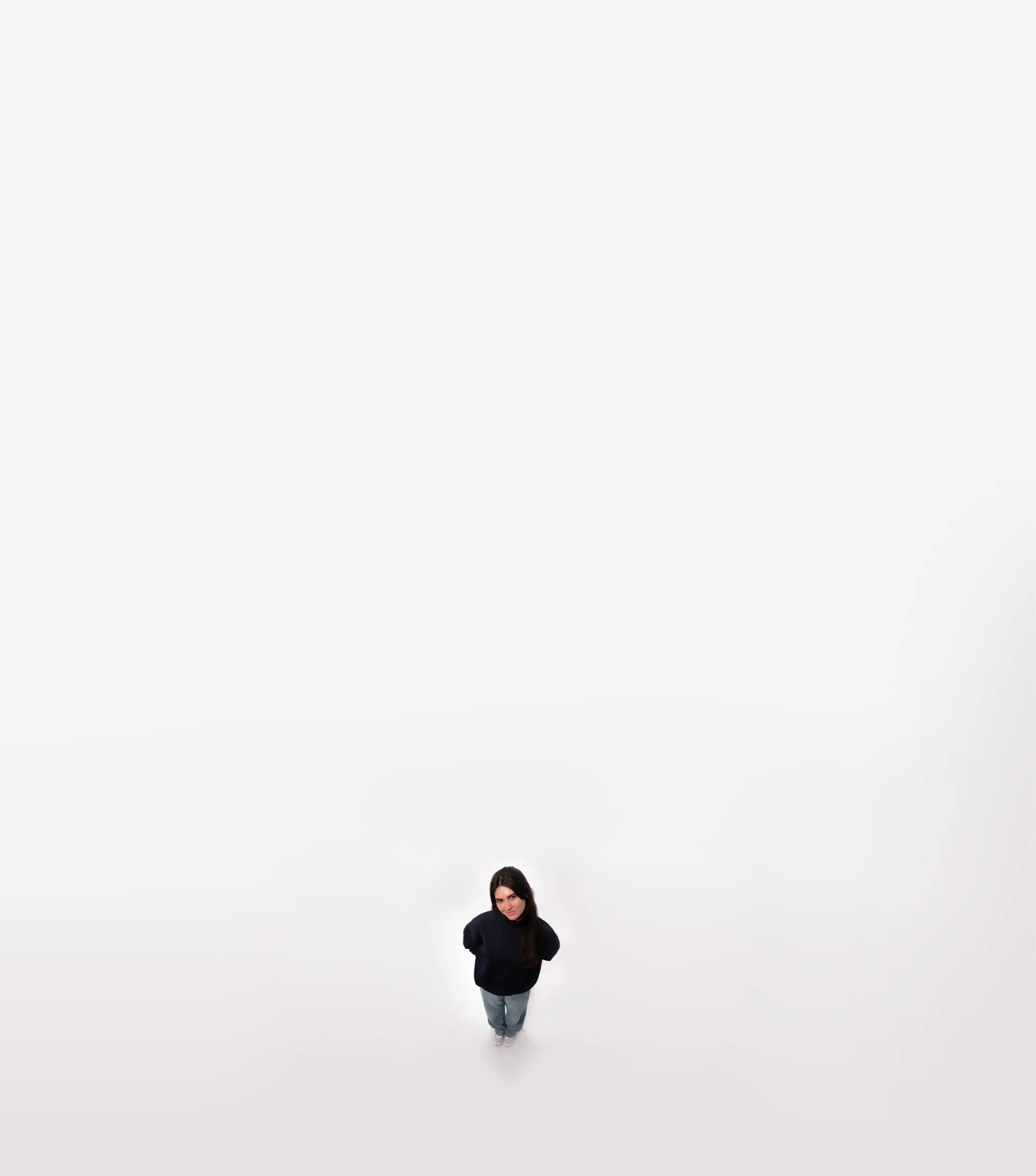 Kerrie, seen from far above, a small figure on a white floor